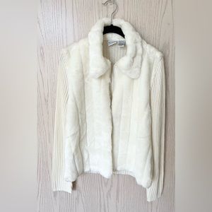 Used cream color long sleeve sweater in a size large with faux fur in the front.
